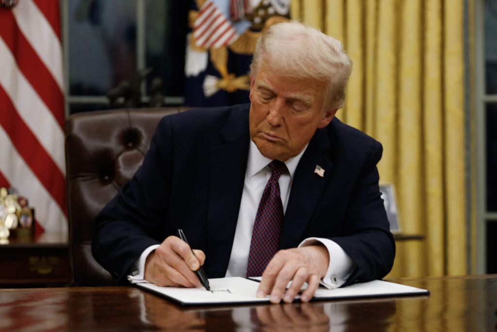 President Donald Trump signs executive orders in the Oval Office of the White House on January 20, 2025 in Washington, DC.
